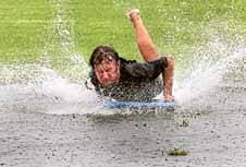 Josh Miller has fun sliding through the water at Port Kembla.