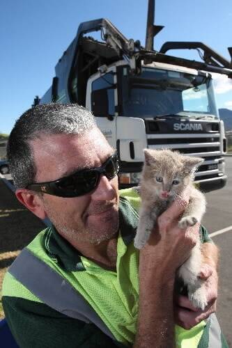Scott Wilson with the kitten which stowed away in the bowels of his garbage truck. Picture: KEN ROBERTSON
