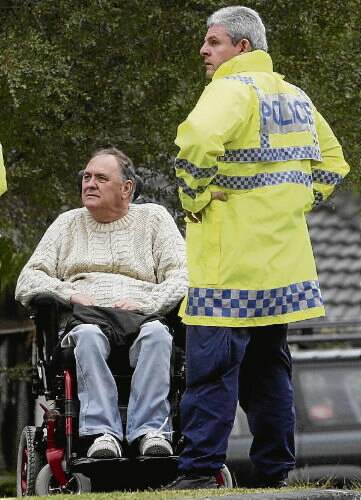 A police officers speaks to a Hobart St resident during the evacuation on Wednesday.
