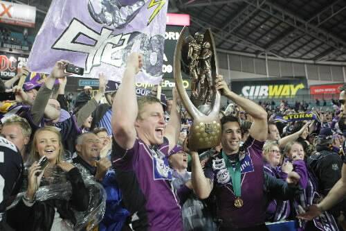 Stripped: The Storm's Billy Slater and Brett Finch  holding aloft the Premiership trophy last year. Picture: STEVE CHRISTO
