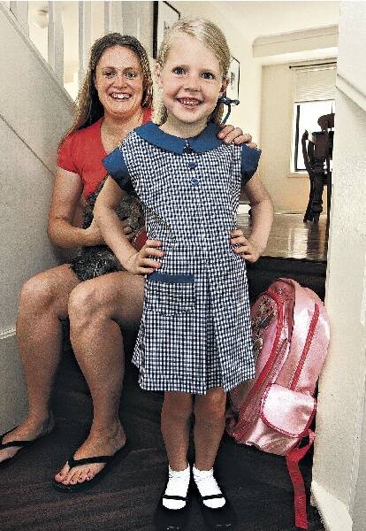 Sarah Davies helps daughter Madison, 5, get ready for her first day at Dapto Public School. Madison suffers from a rare protein deficiency. Picture: ROBERT PEET
