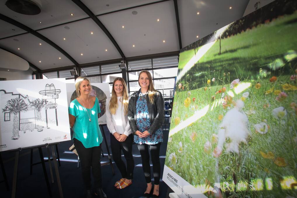 Dani Green, Kate Armstrong and Jessica Bee at the pop-up gallery on the bridge link in Wollongong Central. Picture: ADAM McLEAN