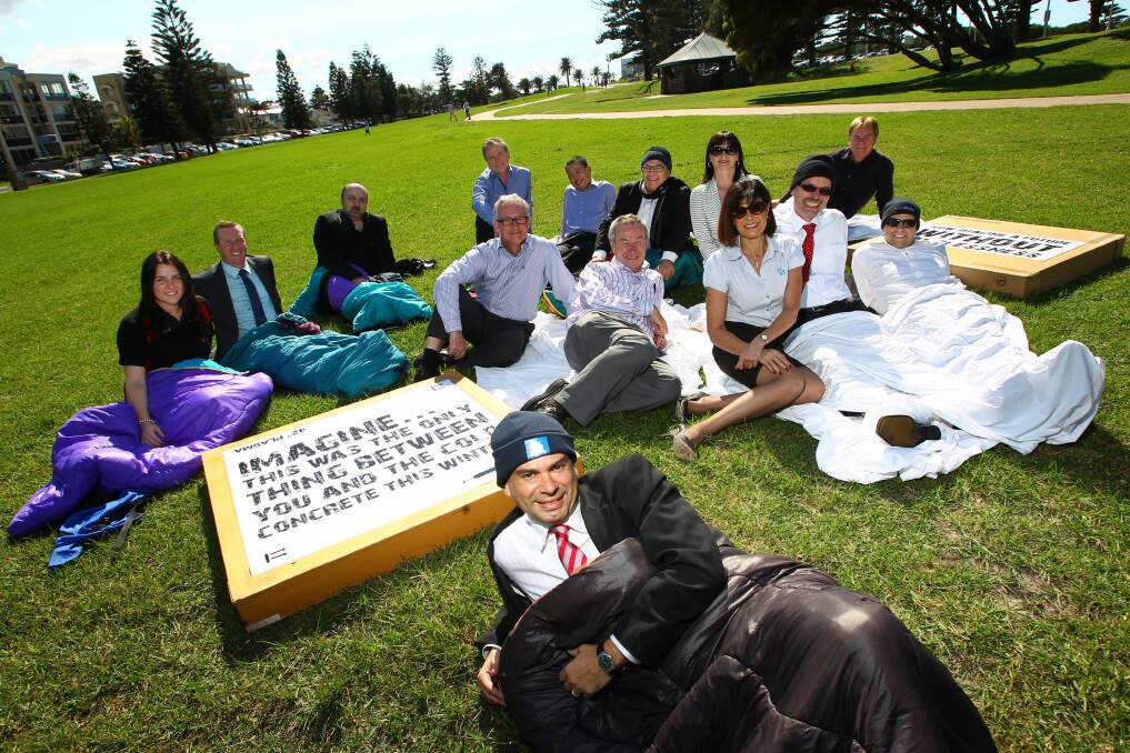 Warwick Shanks of KPMG, (in foreground), will  sleep overnight in Lang Park for the CEO Sleepout. 