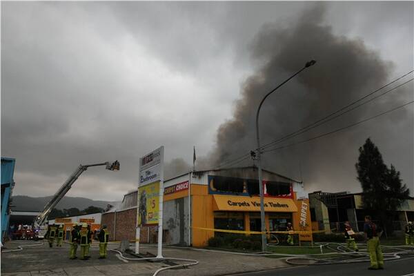 Firefighters bring the blaze under control. Picture: KEN ROBERTSON