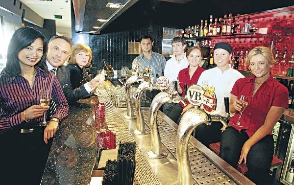 Penny Bell (left), Paul Anzani, Jessie Reid, Dwayne Robinson, Justin Kelly, Samantha Tupper, Rylee Cole and Jessica Glass celebrate the Hotel Illawarra's ranking in the Lonely Planet list of the top 100 bars in the world. Picture: HANK van STUIVENBERG