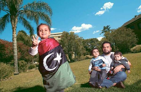 University of Wollongong student Faisel Tubbal and his children, Sarah, Abdulmohimen and Osama, celebrate the death of Libyan dictator Colonel Muammar Gaddafi. Picture: ADAM McLEAN