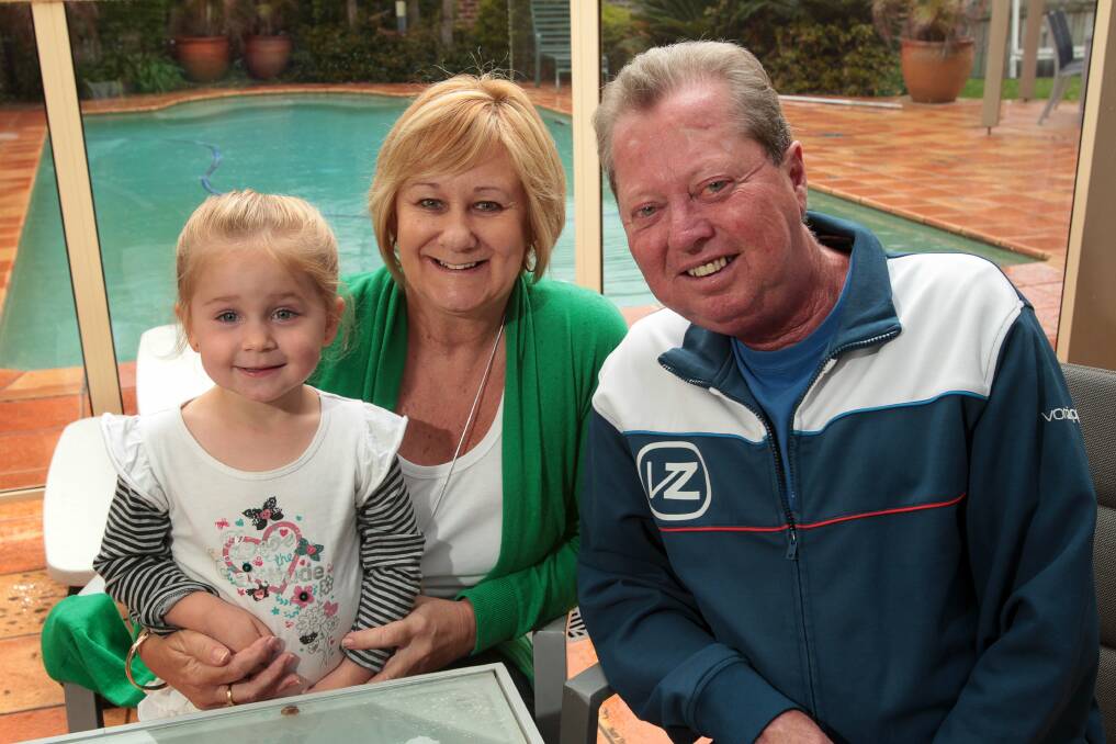 Greg Thurling, his wife Bev and granddaughter Madison at home. Picture: KEN ROBERTSON