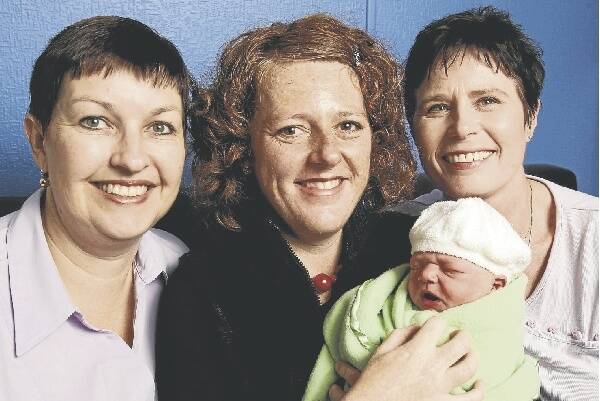 The Illawarra's first publicly funded home birth meant a peaceful arrival in a Coledale cottage for baby Rueben, with midwife Ceri Thomson, mum Claire and midwife Christina Spence. Picture: GREG TOTMAN