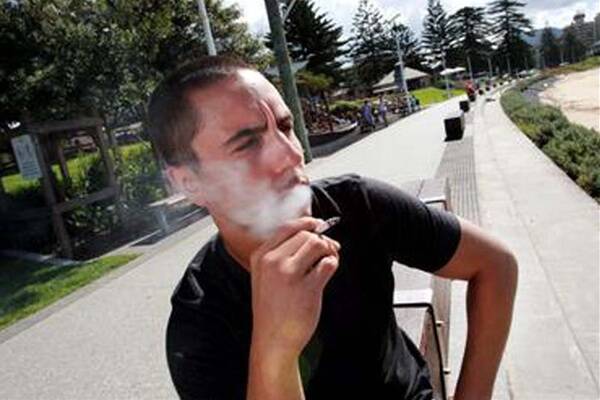 Adam Rondinelli, at Belmore Basin, says the new laws may help him cut back on cigarettes, but a smoking ban at bus stops and taxi ranks is ‘‘ridiculous’’. Picture: ORLANDO CHIODO