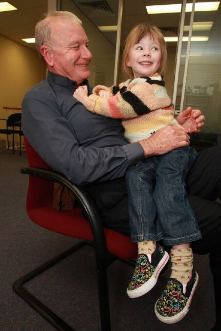 Gordon Bradbery relaxes with his granddaughter Chloe Bradbery, 3, as the results start to come in. PHOTO: Ken Robertson