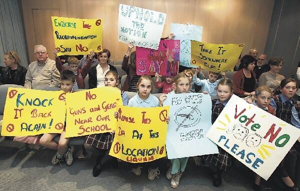 Parents and children from St John Vianney's Primary School at Fairy Meadow protest at last night's council meeting against the proposal to build a gun shop near their school. Picture: ORLANDO CHIODO