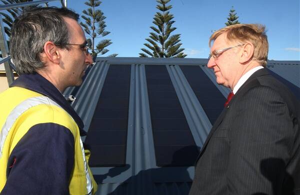 BlueScope's Damian Jinks (left) discusses the BIPV roofing prototype with Energy Minister Martin Ferguson. Picture: ROBERT PEET