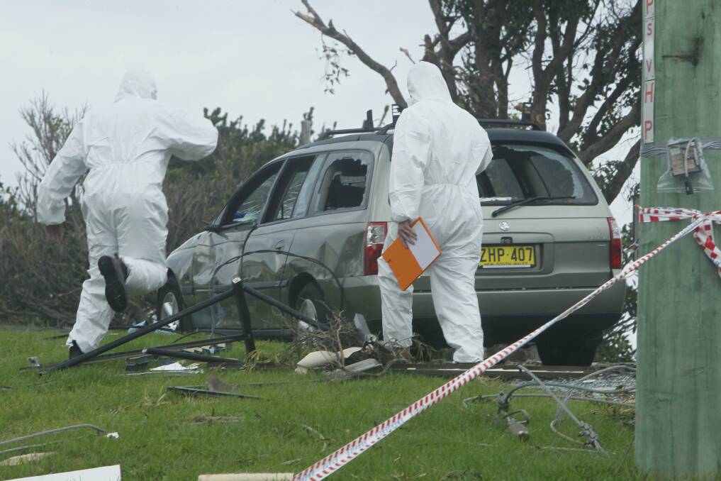 Asbestos experts check a site in Kiama for any sign of the substance. Picture: DAVID TEASE