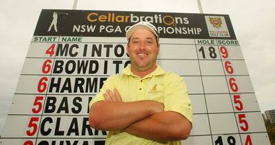 Brad McIntosh with the leaderboard at Wollongong Golf Club after the second round yesterday. He was one shot clear of his rivals in the NSW PGA.Picture: DAVE TEASE