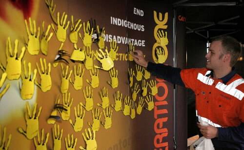 Kurt Elliott of Wollongong adds his hand print to the pledge wall at the GenerationOne roadshow in Crown St Mall yesterday.