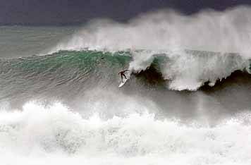 Shaun Anderson rides a wave off Sandon Point.