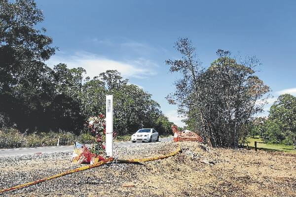 Flowers lie by the side of the road near East Lynne where a tanker (below) collided with three cars, killing four people. Main picture: SYLVIA LIBER