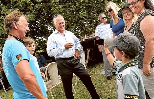Malcolm Turnbull being filmed by eight-year-old Nathan Marsh at Barrack Heights yesterday. Picture: ORLANDO CHIODO