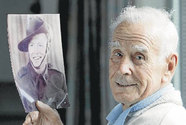 Don Lucas from Coledale holds a photograph of his brother Joe, who was killed when the Australian hospital ship Centaur was torpedoed and sunk. Picture: KIRK GILMOUR