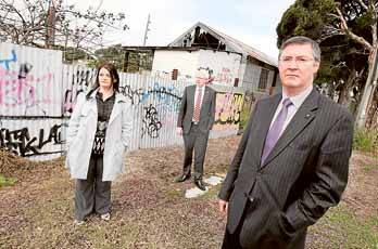 Greg Smith (front), Michelle Blicavs and Gareth Ward take a look at some graffiti on a fence at Albion Park. Picture: ORLANDO CHIODO