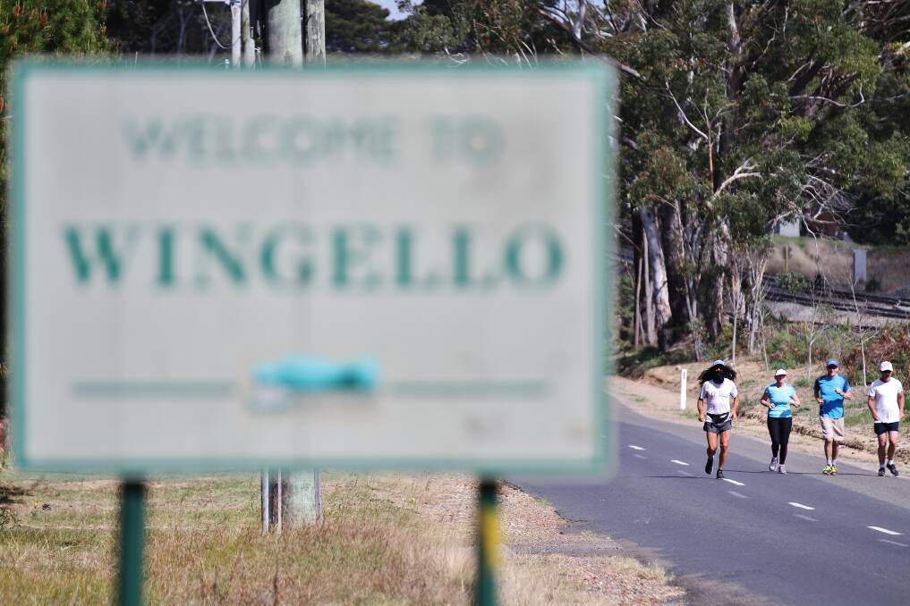 Tom Denniss runs through Wingelo with his cousin and two of his former school teachers. 