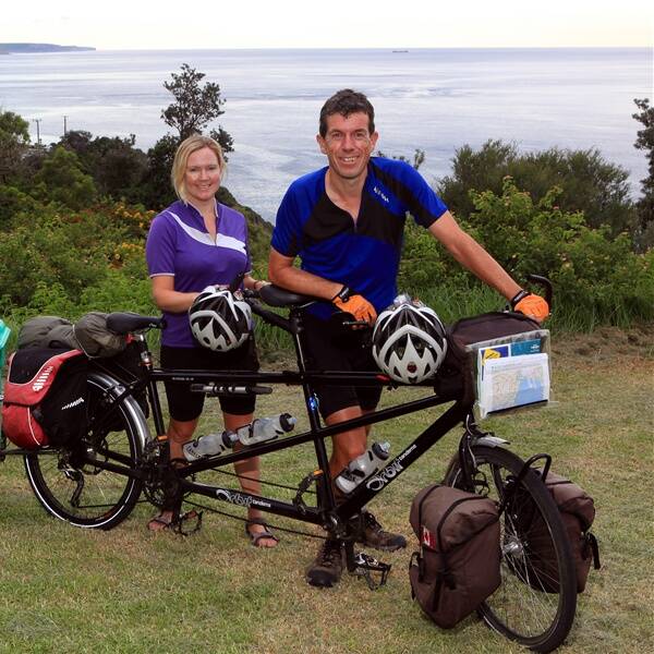 Carolyn and Huw Thomas after crossing Sea Cliff Bridge on a 16,000km bike ride for ShelterBox disaster relief. Picture: KIRK GILMOUR