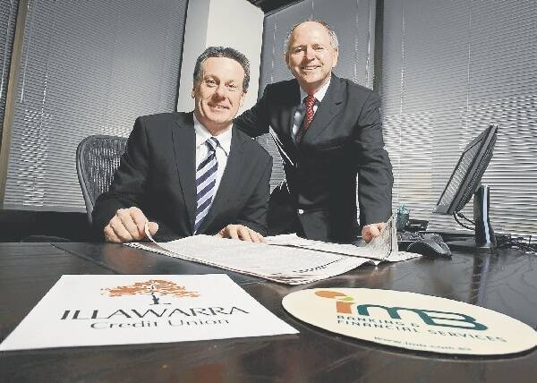IMB CEO Robert Ryan and Illawarra Credit Union CEO Mike Halloran make plans for the merger of the two institutions. Picture: KEN ROBERTSON