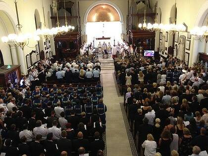 Mourners gather for the funeral of paramedic Mick Wilson. Photo: NICK MOIR