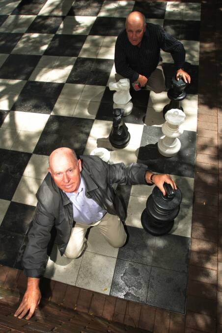 Oscar Murtzan (front) and Mirko Knezevc with the Crown Street Mall chess board. Picture: GREG TOTMAN