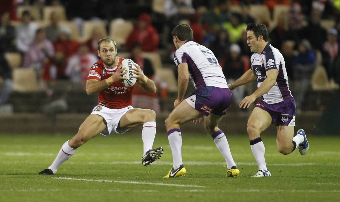 Dragons’ Jason Nightingale takes the ball up against the Storm.