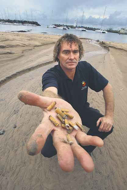 Nuisance: Wollongong council's environmental education co-ordinator Mike McKeon with cigarette butts that were washed into the city's stormwater drains. Picture: KEN ROBERTSON
