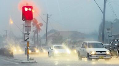 Traffic banks up on Windang Road as heavy rain hits. Picture: DAVE TEASE