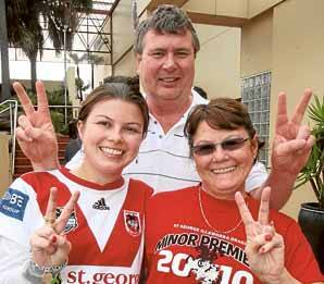 Kylie (left), Garrie and Colleen Heath from Barton Ridge in red and white at the St George Leagues Club yesterday.
