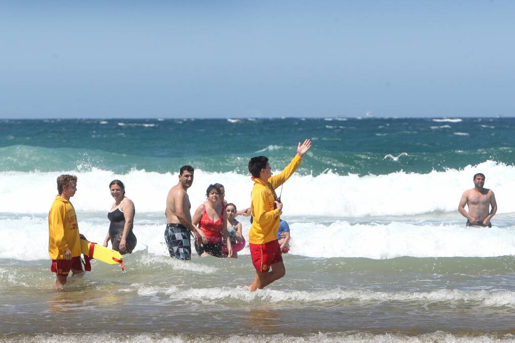 Surf lifesavers instruct swimmers to move away from Puckeys Beach. Picture: SYLVIA LIBER