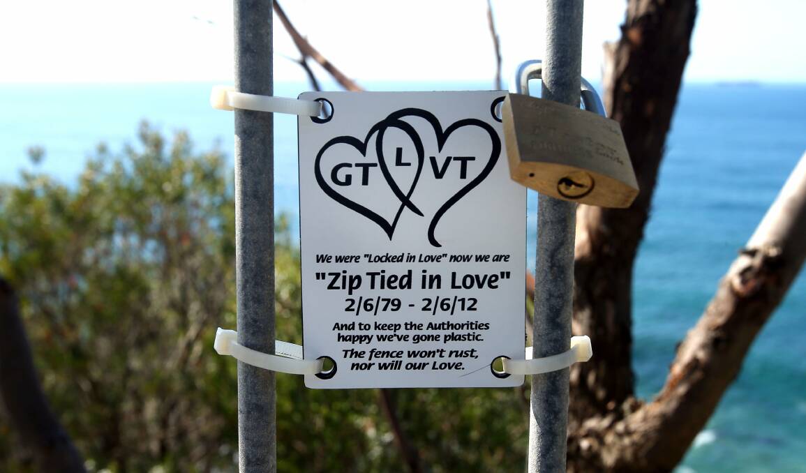 A couple declares their love with a zip-tied plastic plaque. Picture: KIRK GILMOUR