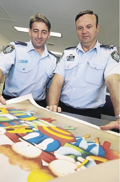 Constable Mick Dunn and Sergeant John Klepczarek with one of the cheap artworks being sold by fake Israeli artists. Picture: ANDY ZAKELI