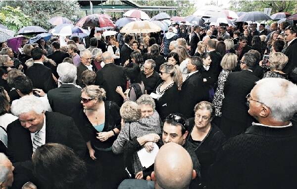 Mourners gather outside the church after Kerryn McCann's funeral in Figtree yesterday. Picture: KEN ROBERTSON  Special mum: McCann and Benton at the 2006 Commonwealth Games after she won the women's marathon.