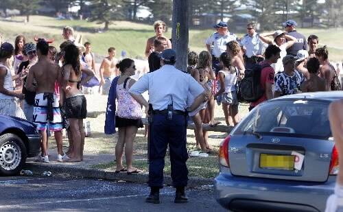 Police watch over the crowds at Surf Beach in Kiama on Monday. Picture: ANDY ZAKELI