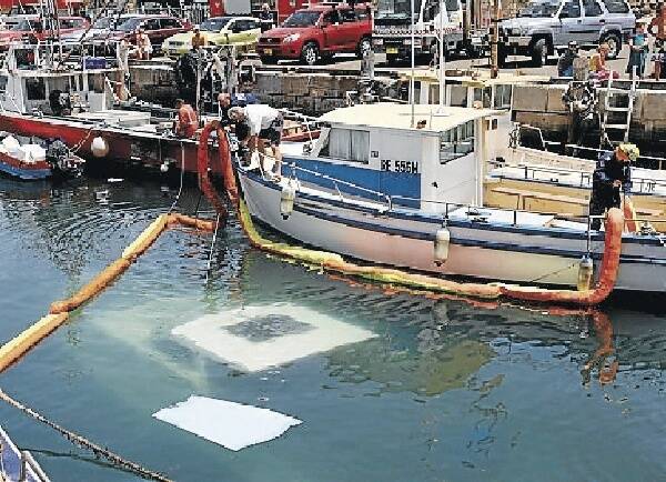 The Aspro is retrieved from the bottom of Wollongong Harbour by an 80-tonne crane yesterday.