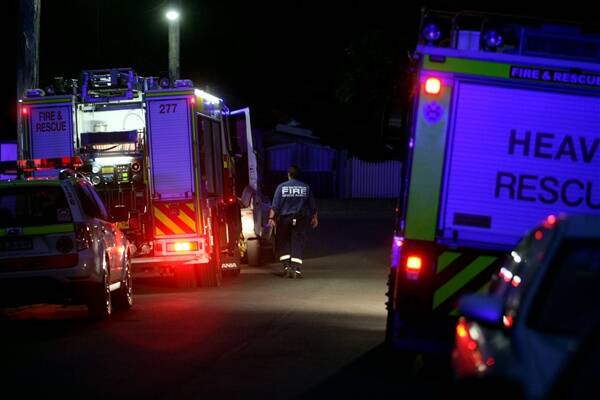 Accident: Rescue crews help stabilise an injured Dapto man at Guligal Rd last night.  Picture: MELANIE RUSSELL