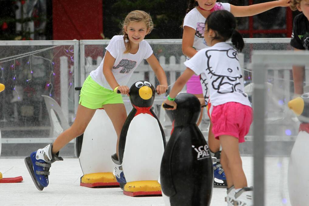 Children take a spin on the ice skating rink at the Crown Street Mall. Picture: GREG TOTMAN