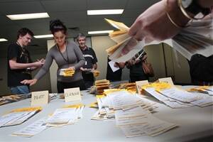 Vote counting takes place at the Electoral Office in Wollongong. Picture: KEN ROBERTSON