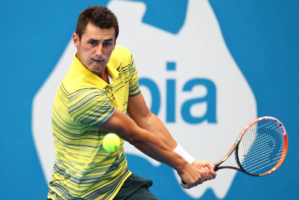 Focus: Bernard Tomic plays a backhand return against Blaz Kavcic in Sydney yesterday. Picture: GETTY IMAGES