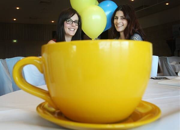 Stefanie and Melissa Gaspari enjoy a cuppa at one of the state's largest Biggest Morning Tea events held at City Beach Function Centre. Picture: MELANIE RUSSELL