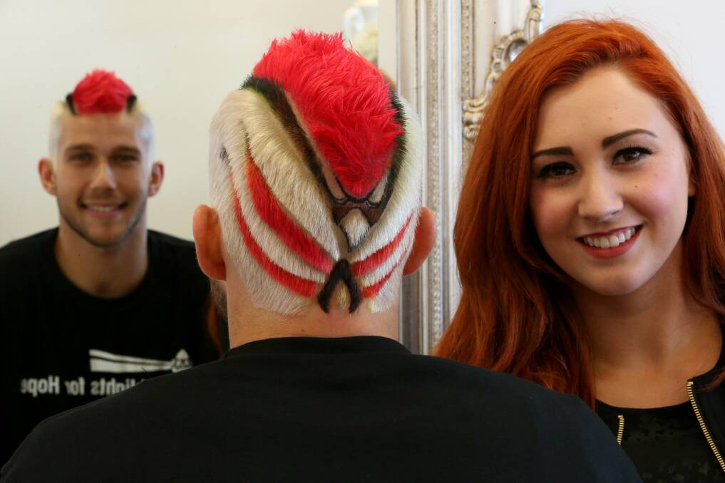 Hawks player Tyson Demos with hairdresser Brittany Kozel. Picture: ROBERT PEET