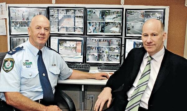 Wollongong City Centre general manager Paul Fanning and Superintendent Wayne Dedden in the CCTV control room. Picture: HANK van STUIVENBERG