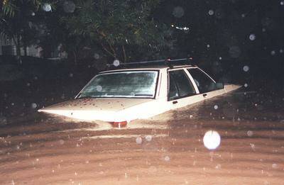A car is submerged by floodwater in 1998 at Fairy Meadow.