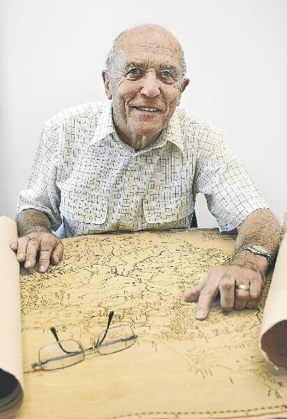 Retired history teacher Ron Hill traces Governor Macquarie's journey through the Illawarra using an early map of the region. Picture: KIRK GILMOUR