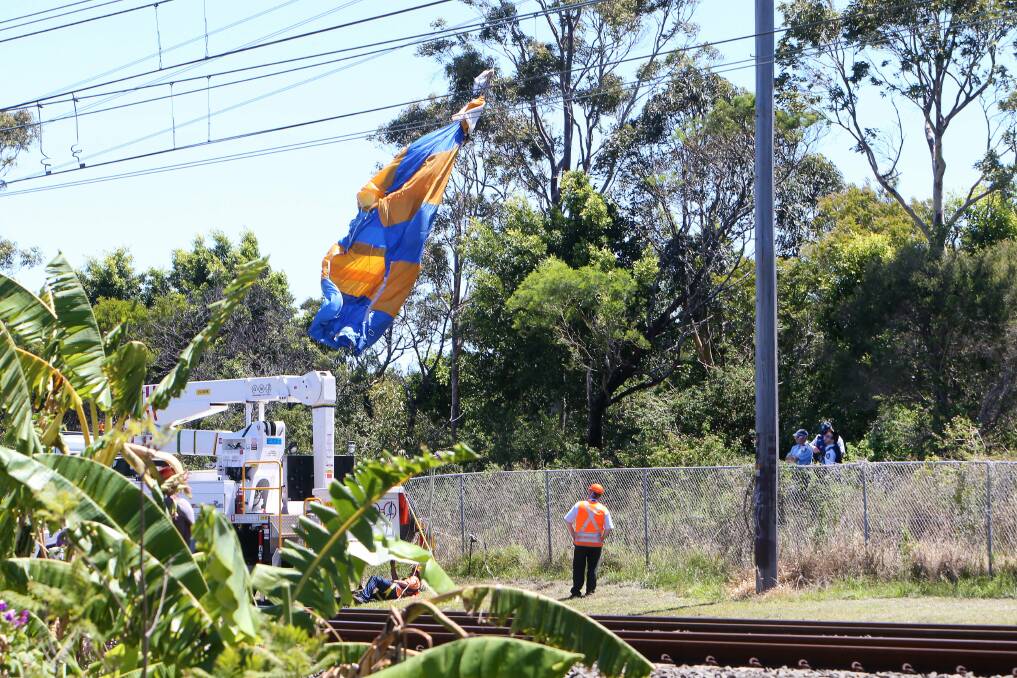 A parachute tangled on power lines next the South Coast rail line between Fairy Meadow and Towradgi. Pictures KIRK GILMOUR