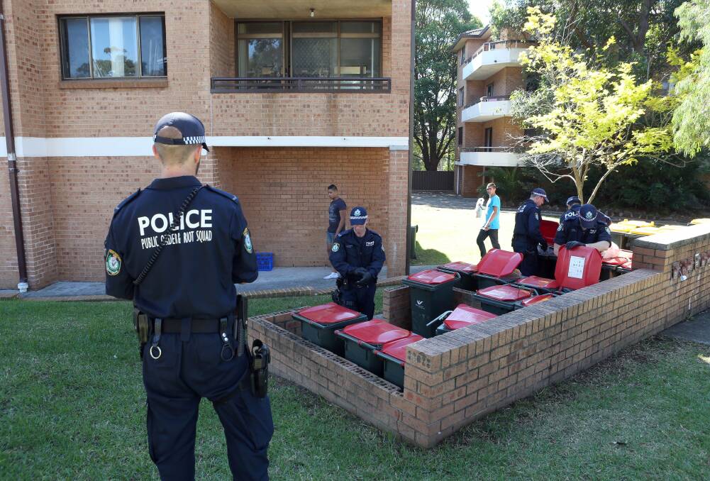 Police at the apartment block in Bligh Street where a woman's body was found in the boot of an abandoned car in Corrimal in April. 